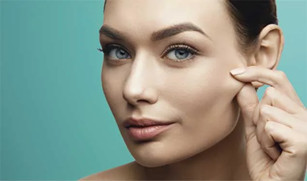 Woman pinching the skin on her cheek for Morpheus8 skin remodelling in London